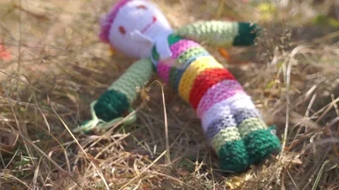 A large soft toy teddy bear lies in the grass Stock Footage 94713768