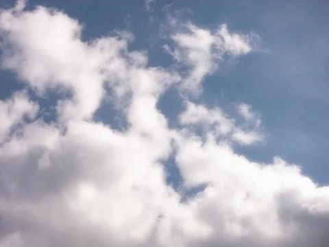 Large Soft White Clouds Filling Much of a Blue Sky Stock Photos