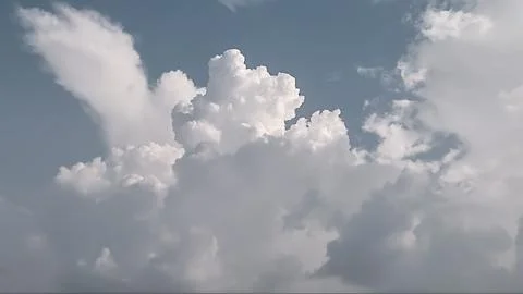 Large soft white glowing clouds covered the blue sky. Black and white clouds Stock Photos