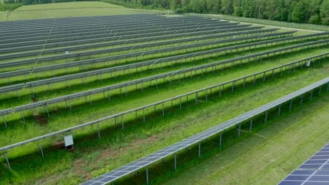 Large solar energy conversion panels are located near the forest. Technology of Stock Footage 155975869