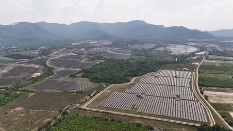 Large solar energy panels fields in tropical valley surrounded mountains. Aerial 스톡 동영상 309440283