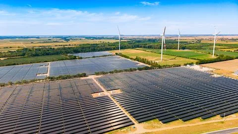 Large solar farm setup next to wind power generators. High angle perspectiv.. Stock Photos