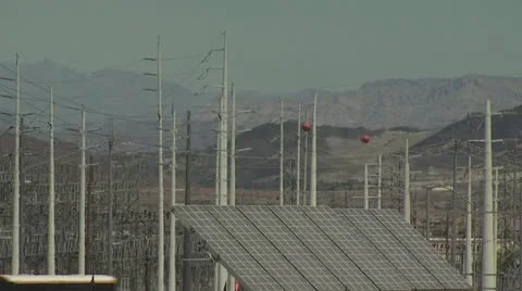 Large Solar Panel and Many Power Poles with Mountain in Background Video stock 19000196