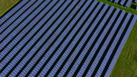 Large solar panel array in a field during the day with clear blue skies and Stock Footage 331960860