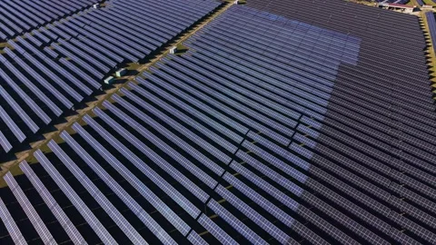 Large solar panel array on a field during bright daylight hours Stock Footage 334030578