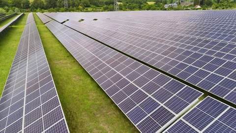 Large solar panel array in a green field, renewable energy farm in rural France Stock Footage 333524468