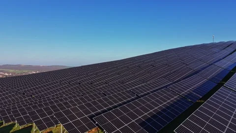 Large solar panel array on a hillside under clear blue sky Stock-Footage 329993643