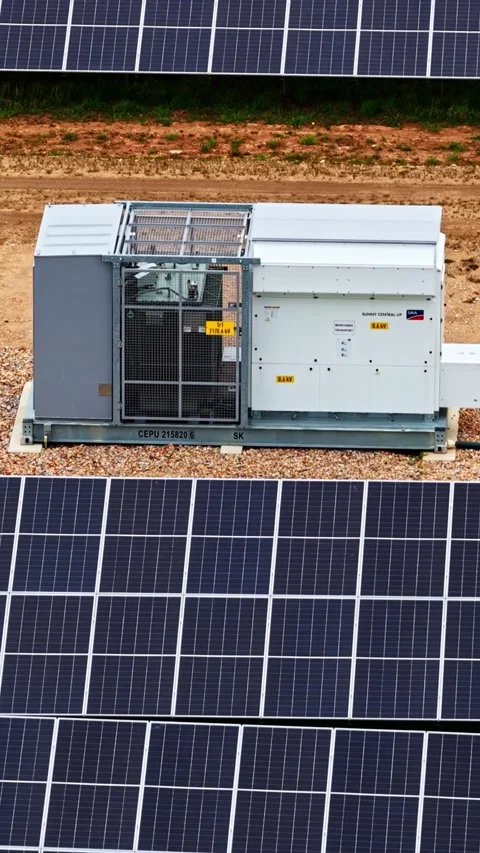 Large solar panel array on rocky ground with industrial electrical equipment. Stock-Footage 336507573