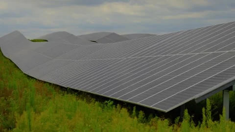 Large Solar Panel Array in Rural Fields Beneath Moody Gray Cloudy Sky Video stock 337554831