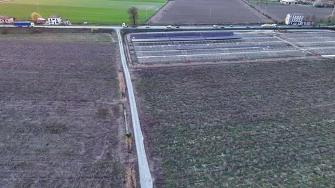 Large solar panel farm construction in agricultural fields, capturing sunli.. Stock Photos