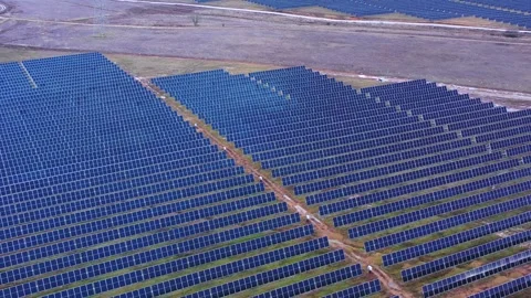 Large Solar Panel Farm Forming Repetitive Lines in Open Rural Landscape Stock Footage 327709496