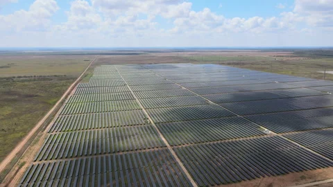 Large solar panel farm harnessing renewable energy in open field Stock Footage 312676919