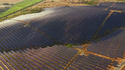 Large solar panel farm located in a sunny region with rows of panels capturing 스톡 동영상 340933477