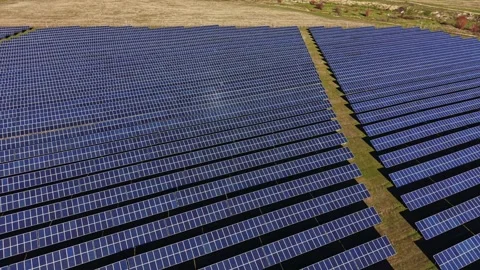 Large solar panel field in a rural area on a sunny day 動画素材 334030200