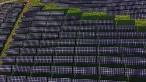 Large solar panel installation covers flat field under clear sky Stock Footage 330000132