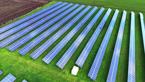 Large solar panel installation viewed from above in a green landscape Stock Footage 325088041