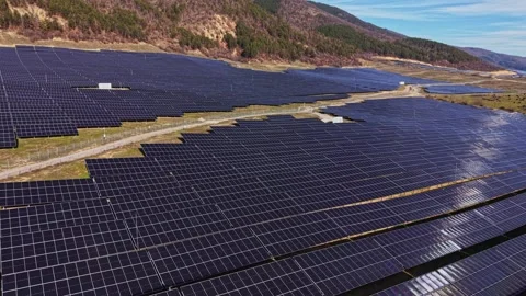 Large solar power farm with many solar panels in a green landscape Stock Footage 334032829