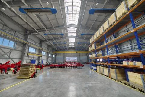 Large, spacious assembly shop. High storage racks with wooden boxes Stock Photos