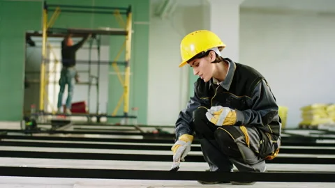 Large spacious building in construction working concentrated charismatic woman Stock Footage 219565145