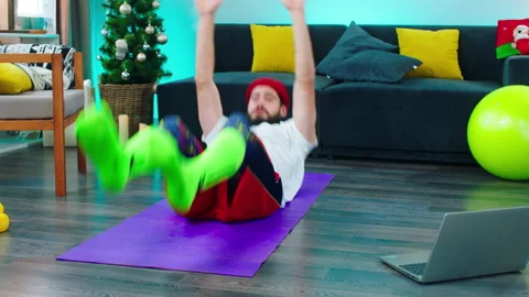 Large spacious living room guy doing the workout exercises using a sport mat and Stock Footage 160806785