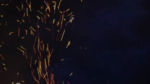 Large sparks from a fire against a black sky Stock Footage 159656973