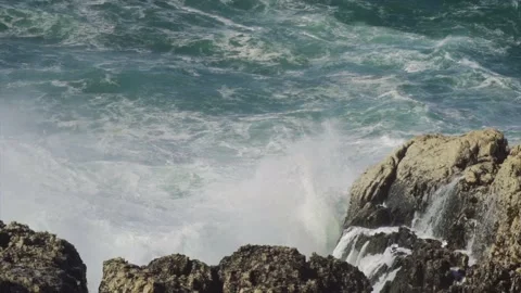 Large splash and sea spray from big wave hitting Mediterranean coast Stock Footage 168773639