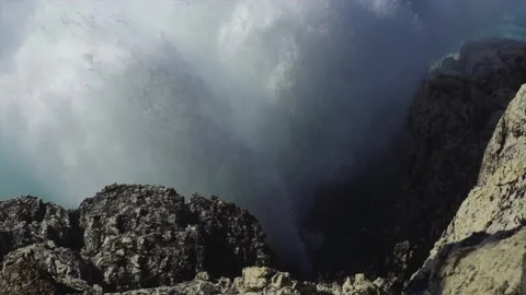 Large splash created by big wave hitting rocks on coast Stock Footage 168773612