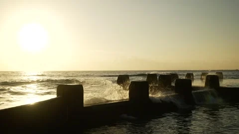 A large splash at sunrise next to Sydney's Coogee Ocean Pool 6K Stock Footage 307164701
