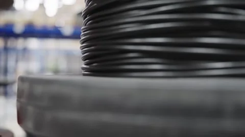 Large spools of industrial cable materials are neatly stored in a production  Stock Footage 308656976
