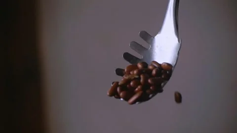 Large spoon pouring multiple Red Kidney Beans in Slow Motion Close Up Stock Footage 339971736