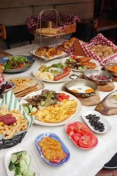 Large spread of turkish breakfast on dining table in outdoor setting Stock Photos