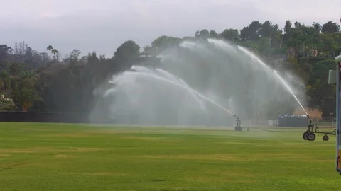 Large Sprinkler System Waters Polo and Soccer Pitch Stock Footage 92500251