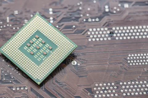 A large square microprocessor for computers lies on motherboard 写真素材