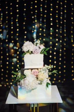 Large square wedding cake with three floors. Against the backdrop of led Stock Photos