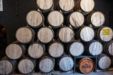 Large stack of aging tequila barrels inside a traditional Mexican distillery Stock Photos