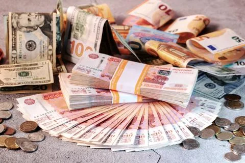 Large stack of banknotes, Russian rubles laying on a grey concrete surface Stock Photos