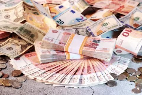 Large stack of banknotes, Russian rubles laying on a grey concrete surface Stock Photos