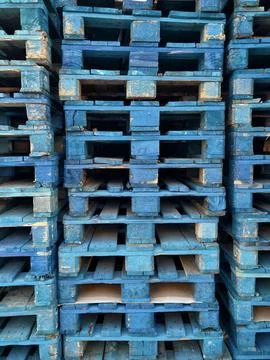 Large Stack of Blue Wooden Pallets Arranged in Vertical Columns Stock Photos