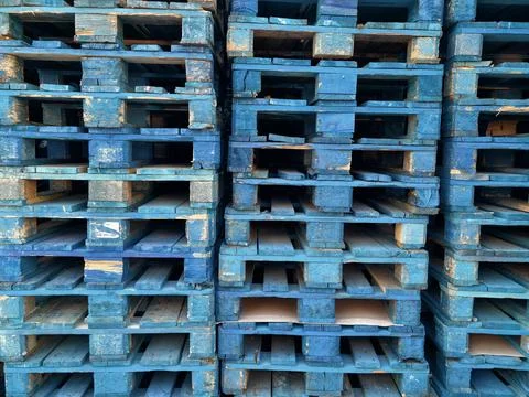 Large Stack of Blue Wooden Pallets Arranged in Vertical Columns Stock Photos