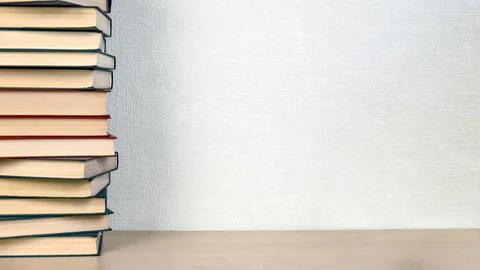 A large stack of books is on the shelf. The concept of reading, education Stock Photos