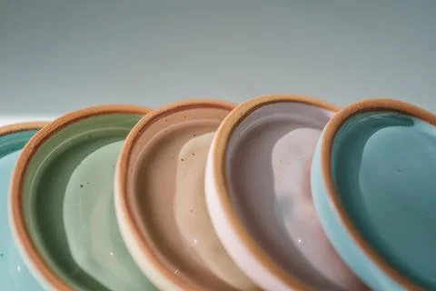 A large stack of ceramic cups in pastel colors. Stock Photos
