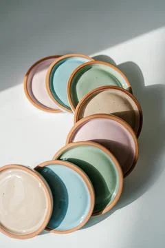 A large stack of ceramic cups in pastel colors. Stock Photos