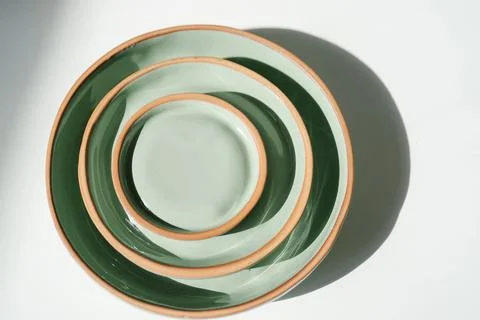 A large stack of ceramic cups in pastel green color. Stock Photos