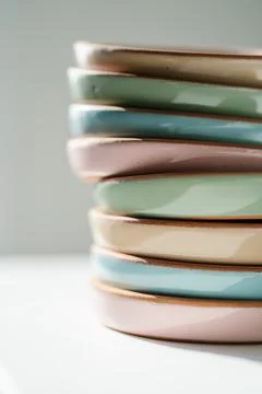 A large stack of ceramic cups in pastel colors. Stock Photos