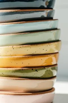 A large stack of ceramic cups in pastel colors. Stock Photos