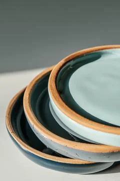 A large stack of ceramic cups in pastel colors. Stock Photos