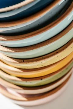 A large stack of ceramic cups in pastel colors. Stock Photos