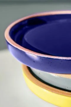 A large stack of ceramic cups in pastel colors. Stock Photos