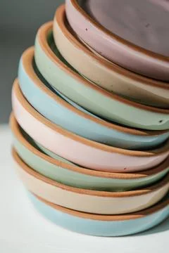A large stack of ceramic cups in pastel colors. A large stack of ceramic c... Stock Photos