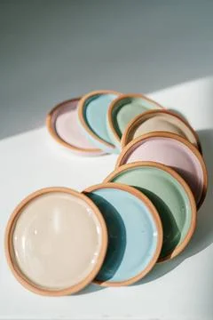 A large stack of ceramic cups in pastel colors. A large stack of ceramic c... Stock Photos